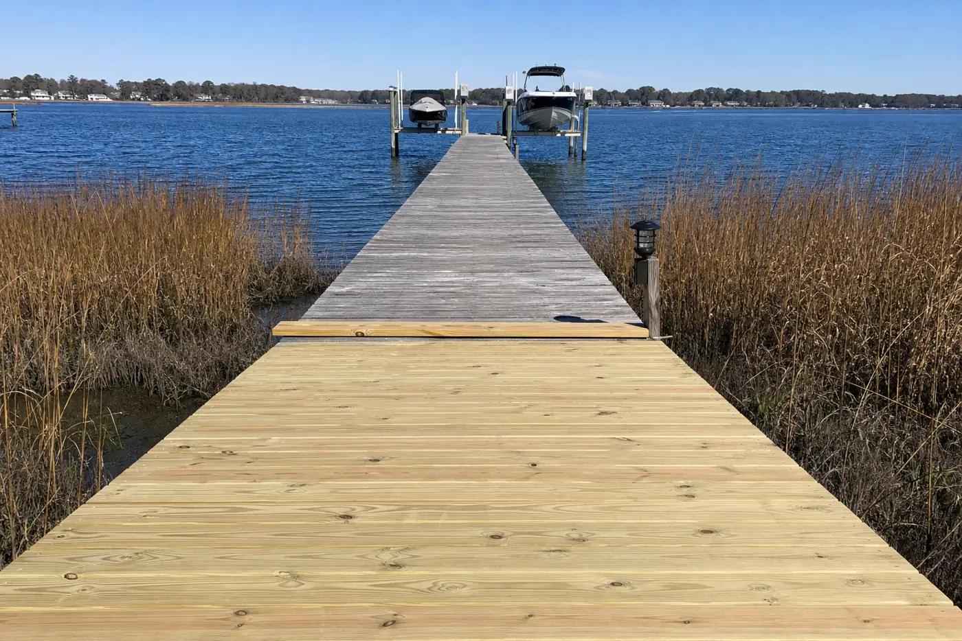 In-progress pier re-decking, new boards meeting weathered boards